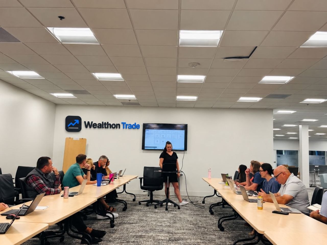 A Wealthon Trade platform walkthrough with clients gathered around a boardroom table