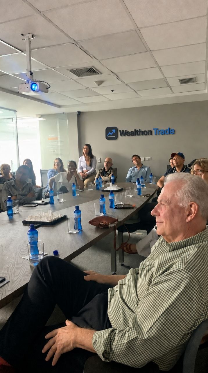 Clients listening to a strategy briefing in a Wealthon Trade meeting room